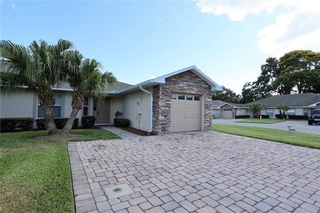 1749 Christina Lee Ln, Saint Cloud, FL 34769 - ranch-style house featuring decorative driveway, stucco siding, a garage, a front yard, and stone siding