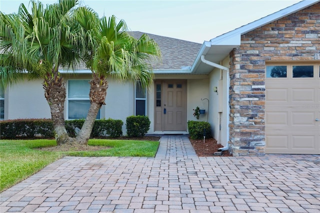 1749 Christina Lee Ln, Saint Cloud, FL 34769 - entrance to property featuring stucco siding, an attached garage, and stone siding