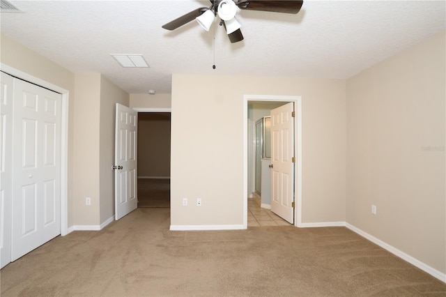 1749 Christina Lee Ln, Saint Cloud, FL 34769 - unfurnished bedroom featuring carpet floors, a textured ceiling, a closet, connected bathroom, and ceiling fan