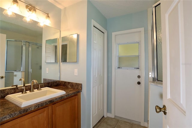 1749 Christina Lee Ln, Saint Cloud, FL 34769 - full bathroom featuring vanity, a shower with door, tile patterned flooring, and a closet