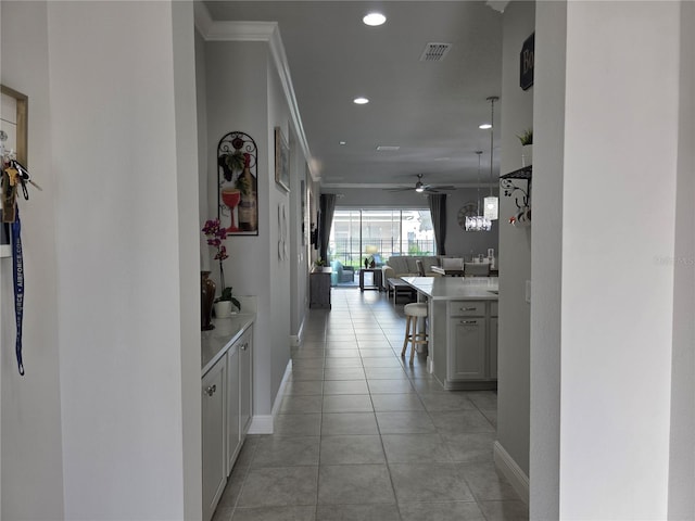2853 Willowseed Ln, Saint Cloud, FL 34772 - corridor with recessed lighting, ornamental molding, and light tile patterned floors