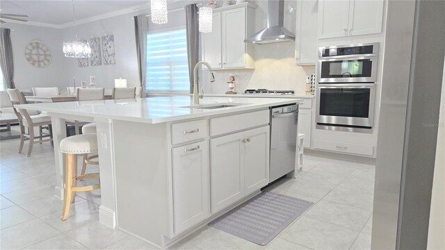 2853 Willowseed Ln, Saint Cloud, FL 34772 - kitchen featuring wall chimney range hood, appliances with stainless steel finishes, crown molding, tasteful backsplash, and light countertops