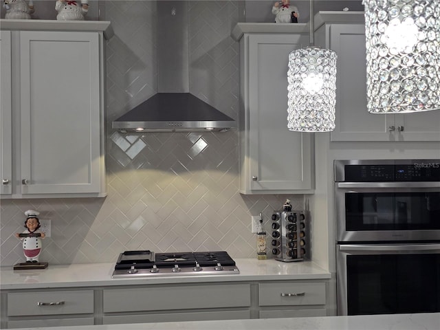 2853 Willowseed Ln, Saint Cloud, FL 34772 - kitchen featuring stainless steel appliances, wall chimney exhaust hood, tasteful backsplash, and light countertops