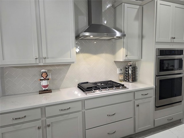 2853 Willowseed Ln, Saint Cloud, FL 34772 - kitchen with wall chimney exhaust hood, appliances with stainless steel finishes, tasteful backsplash, and light stone countertops