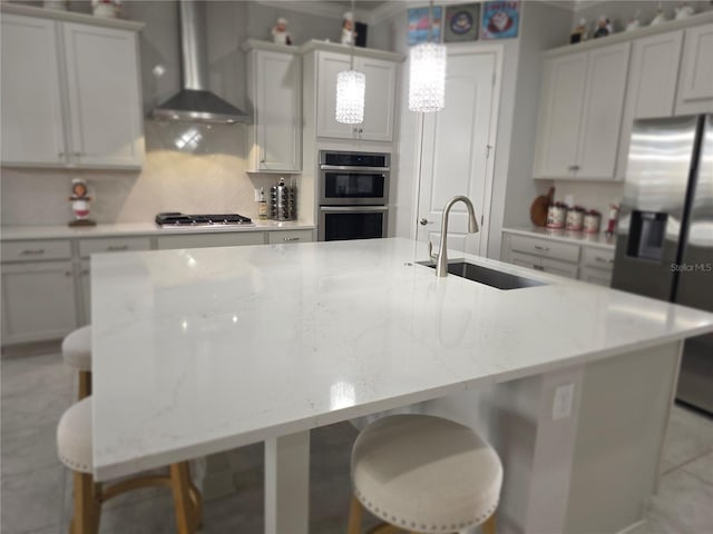 2853 Willowseed Ln, Saint Cloud, FL 34772 - kitchen with stainless steel appliances, wall chimney range hood, a spacious island, and a kitchen breakfast bar