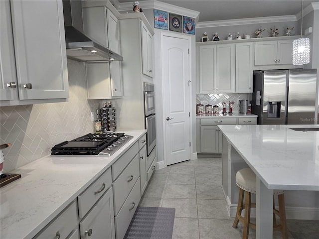 2853 Willowseed Ln, Saint Cloud, FL 34772 - kitchen with appliances with stainless steel finishes, wall chimney range hood, tasteful backsplash, decorative light fixtures, and light tile patterned floors