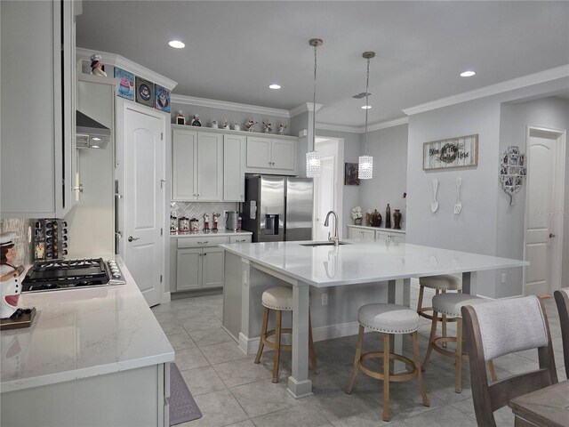 2853 Willowseed Ln, Saint Cloud, FL 34772 - kitchen featuring stainless steel appliances, ventilation hood, tasteful backsplash, recessed lighting, and a kitchen bar