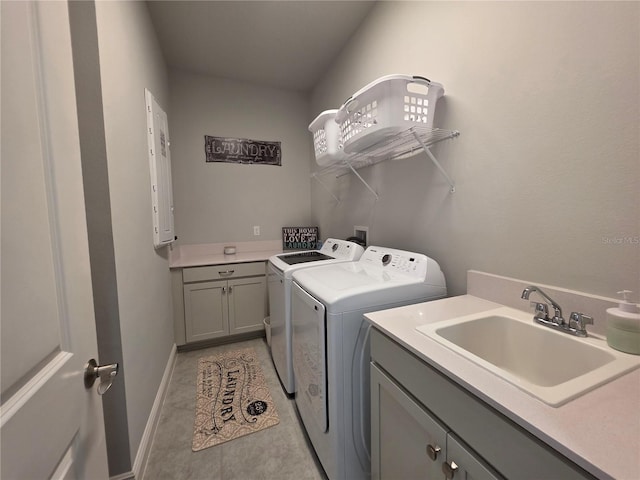 2853 Willowseed Ln, Saint Cloud, FL 34772 - washroom featuring washer and dryer, cabinet space, and light tile patterned floors