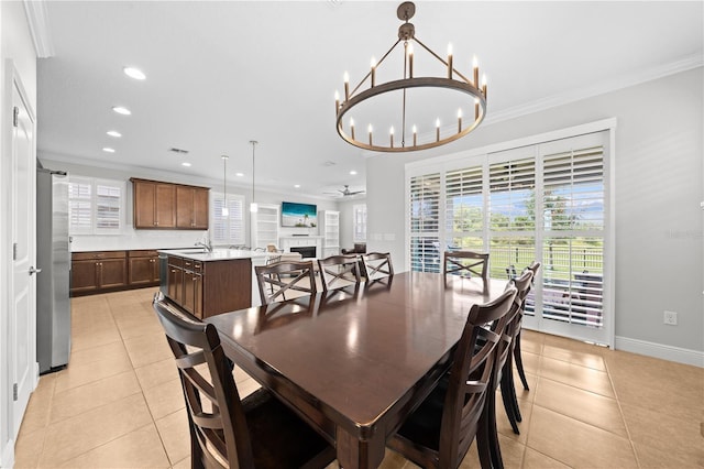 3204 Oxbow Ct, Saint Cloud, FL 34773 - dining room featuring light tile patterned floors, ornamental molding, recessed lighting, a chandelier, and a fireplace