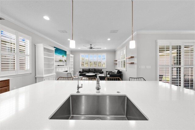 3204 Oxbow Ct, Saint Cloud, FL 34773 - kitchen with ceiling fan, ornamental molding, hanging light fixtures, recessed lighting, and light countertops