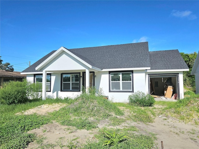 1236 N Virginia Ave, Lakeland, FL 33805 - view of front of house featuring stucco siding, a shingled roof, and an attached garage