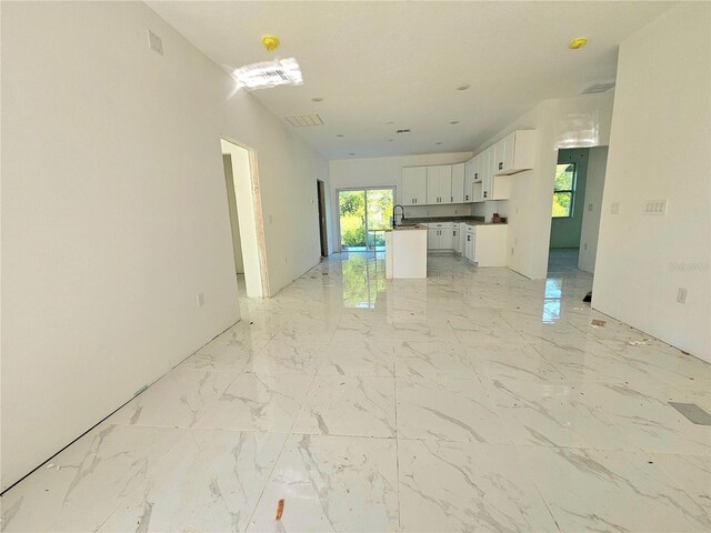 1236 N Virginia Ave, Lakeland, FL 33805 - unfurnished living room with light marble finish flooring