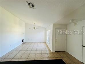 851 Adour Dr Unit A-B, Kissimmee, FL 34759 - foyer entrance with ceiling fan, lofted ceiling, and light tile patterned floors