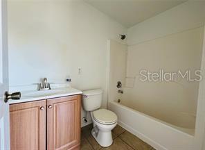 851 Adour Dr Unit A-B, Kissimmee, FL 34759 - full bathroom featuring vanity, shower / tub combination, and tile patterned floors