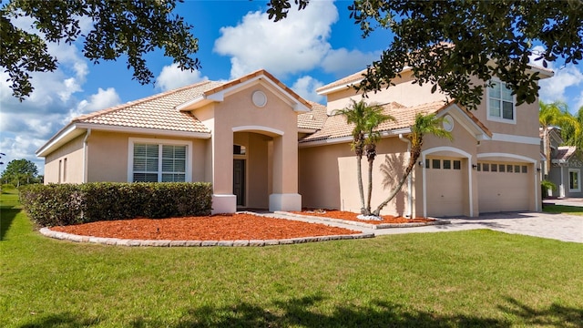 1950 Windward Oaks Ct, Kissimmee, FL 34746 - mediterranean / spanish-style home with a tile roof, an attached garage, stucco siding, and driveway