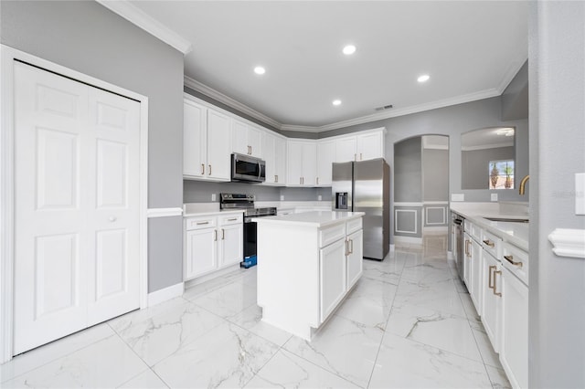 1950 Windward Oaks Ct, Kissimmee, FL 34746 - kitchen with stainless steel appliances, ornamental molding, light countertops, light marble finish flooring, and arched walkways