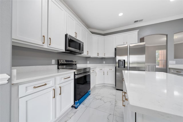 1950 Windward Oaks Ct, Kissimmee, FL 34746 - kitchen featuring appliances with stainless steel finishes, crown molding, light marble finish floors, arched walkways, and white cabinetry