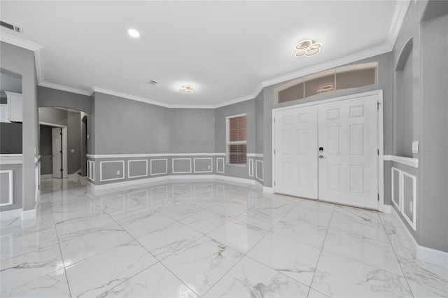 1950 Windward Oaks Ct, Kissimmee, FL 34746 - entrance foyer featuring arched walkways, a decorative wall, crown molding, wainscoting, and marble finish floors