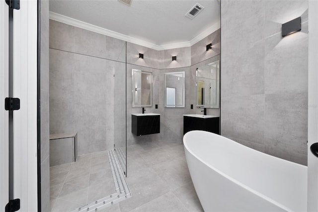 1950 Windward Oaks Ct, Kissimmee, FL 34746 - bathroom with a soaking tub, crown molding, a stall shower, double vanity, and a textured ceiling