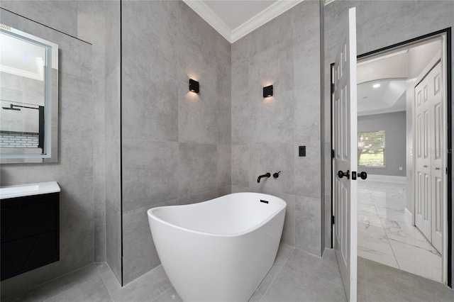 1950 Windward Oaks Ct, Kissimmee, FL 34746 - bathroom featuring crown molding, a soaking tub, vanity, and tile walls