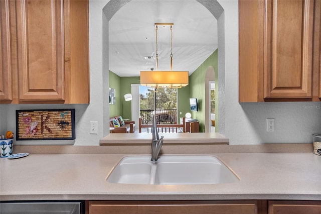 1351 Venezia Ct Unit 201, Davenport, FL 33896 - kitchen with track lighting, light countertops, arched walkways, and dishwasher
