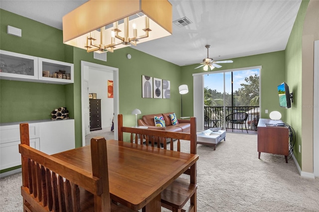 1351 Venezia Ct Unit 201, Davenport, FL 33896 - dining space featuring light colored carpet, a ceiling fan, and a chandelier
