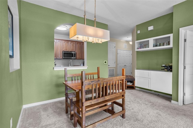 1351 Venezia Ct Unit 201, Davenport, FL 33896 - dining space featuring light colored carpet and a chandelier