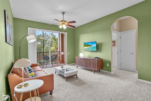 1351 Venezia Ct Unit 201, Davenport, FL 33896 - living room with arched walkways, a ceiling fan, carpet floors, and a textured wall