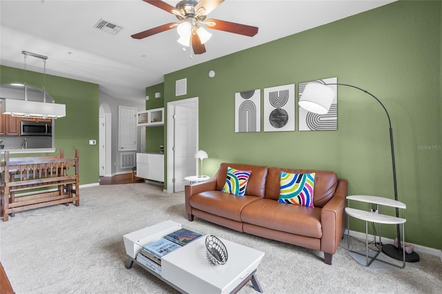 1351 Venezia Ct Unit 201, Davenport, FL 33896 - carpeted living room featuring ceiling fan and arched walkways