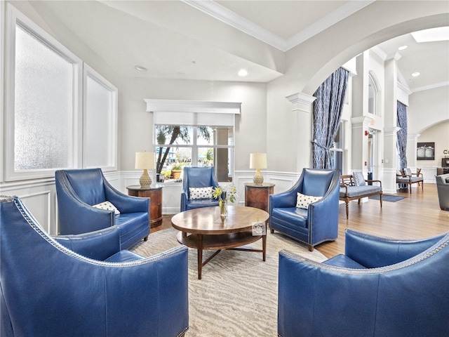1351 Venezia Ct Unit 201, Davenport, FL 33896 - living area with arched walkways, ornate columns, a decorative wall, wood finished floors, and crown molding