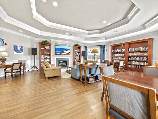 1351 Venezia Ct Unit 201, Davenport, FL 33896 - living room with a raised ceiling, ornamental molding, a glass covered fireplace, light wood finished floors, and recessed lighting