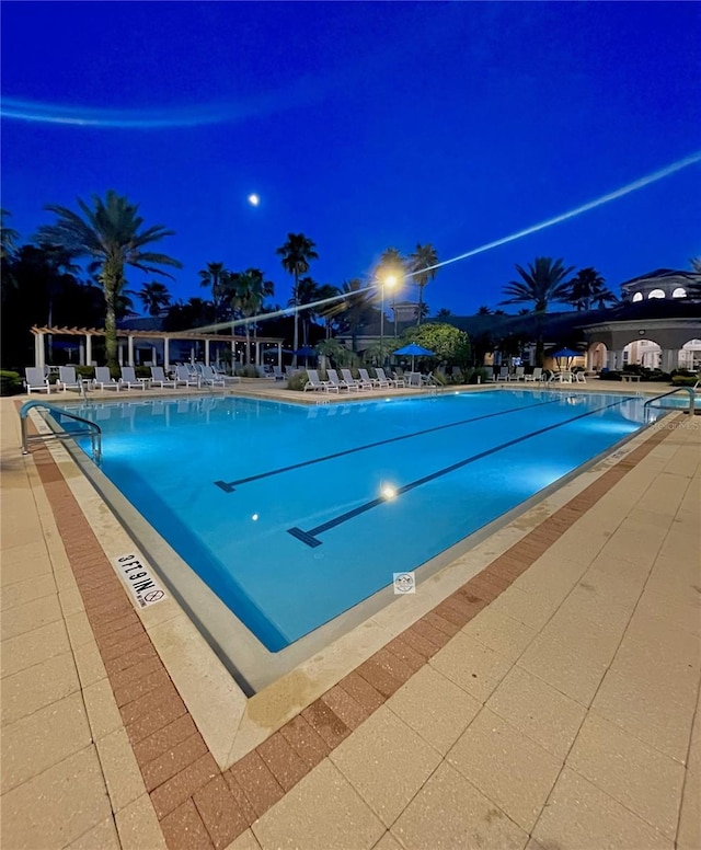 1351 Venezia Ct Unit 201, Davenport, FL 33896 - pool at night featuring a community pool and a patio