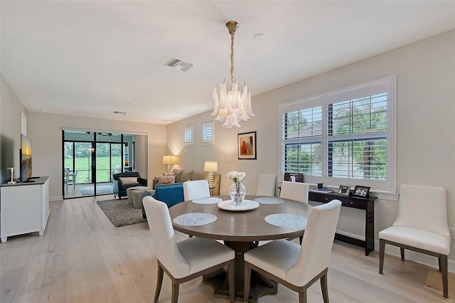 17109 Kenton Ter, Bradenton, FL 34202 - dining area with a chandelier and light wood-style flooring