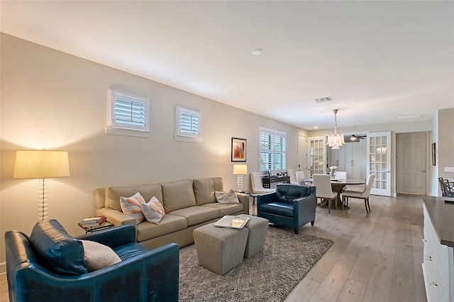17109 Kenton Ter, Bradenton, FL 34202 - living area with light wood-type flooring and a chandelier