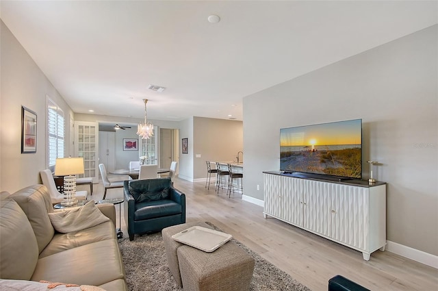 17109 Kenton Ter, Bradenton, FL 34202 - living room with light wood-style floors and a chandelier