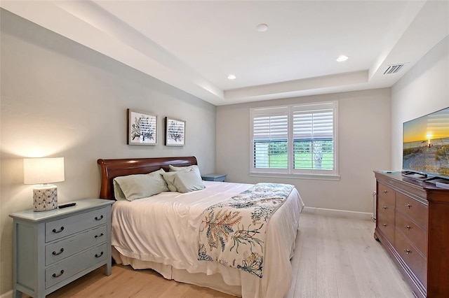 17109 Kenton Ter, Bradenton, FL 34202 - bedroom with light wood finished floors, a raised ceiling, and recessed lighting