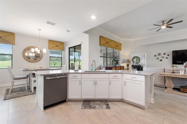 1452 Mickelson Ct, Davenport, FL 33896 - kitchen featuring stainless steel dishwasher, open floor plan, a chandelier, light countertops, and white cabinets