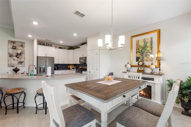 1452 Mickelson Ct, Davenport, FL 33896 - dining room with a chandelier, recessed lighting, and a fireplace