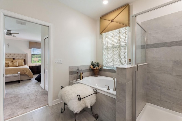 1452 Mickelson Ct, Davenport, FL 33896 - full bathroom with ensuite bath, a garden tub, a shower stall, a ceiling fan, and tile patterned flooring