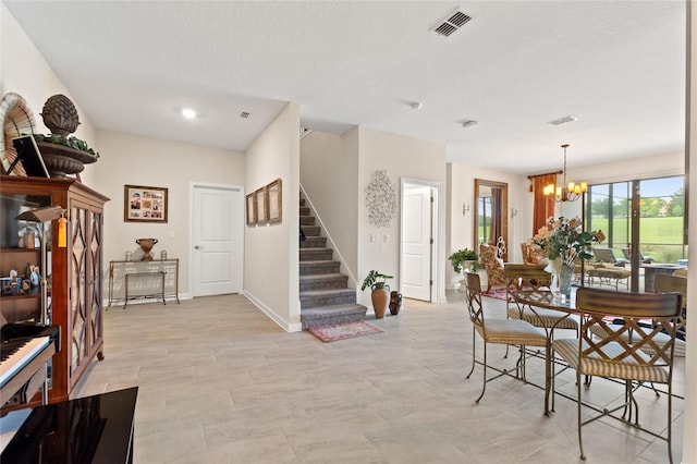 1452 Mickelson Ct, Davenport, FL 33896 - dining area featuring a chandelier and stairs