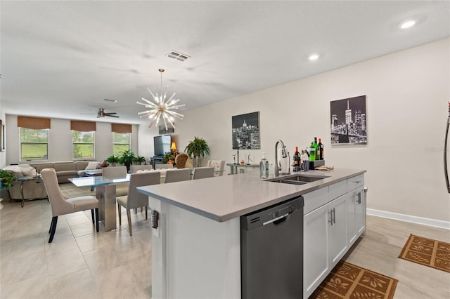 1452 Mickelson Ct, Davenport, FL 33896 - kitchen with stainless steel dishwasher, open floor plan, white cabinetry, an island with sink, and light countertops