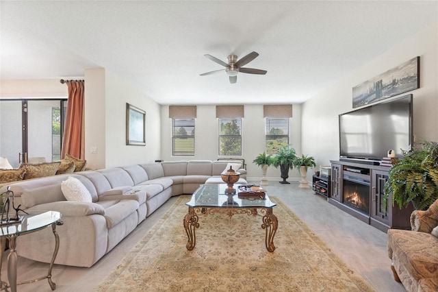 1452 Mickelson Ct, Davenport, FL 33896 - living room featuring ceiling fan, a glass covered fireplace, and light wood-style flooring
