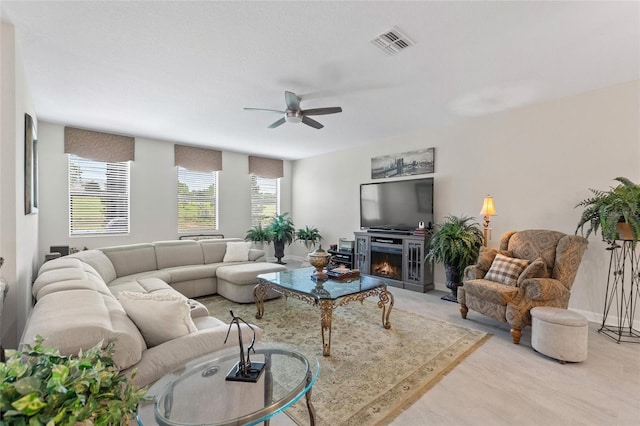 1452 Mickelson Ct, Davenport, FL 33896 - living area with ceiling fan, plenty of natural light, and a warm lit fireplace