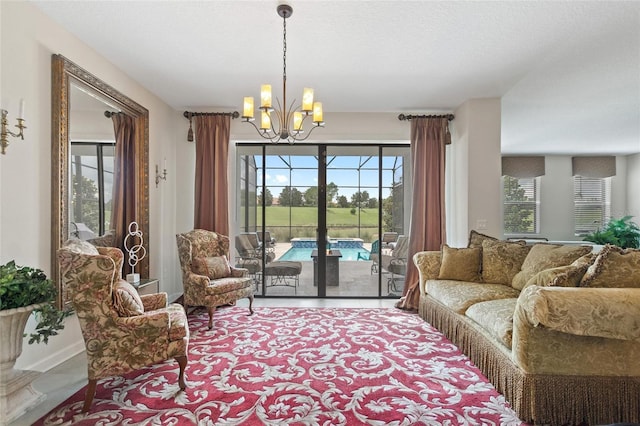 1452 Mickelson Ct, Davenport, FL 33896 - living room with a chandelier and healthy amount of natural light