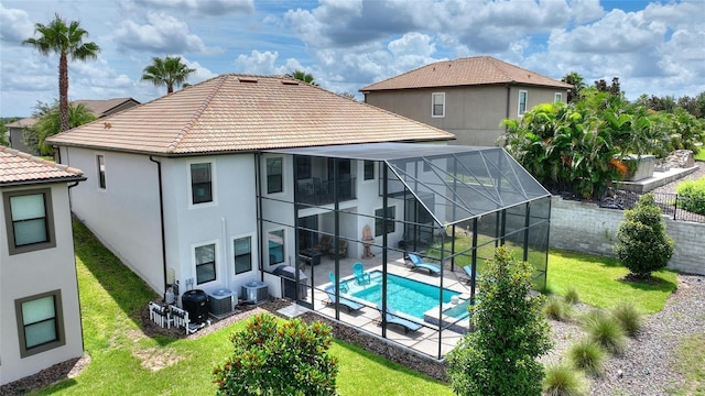 1452 Mickelson Ct, Davenport, FL 33896 - rear view of house with a patio area, stucco siding, a tiled roof, and a lanai