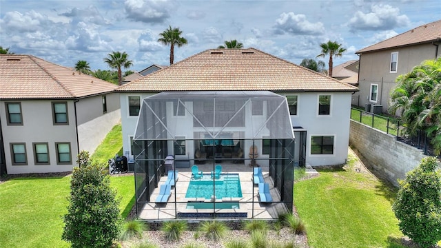 1452 Mickelson Ct, Davenport, FL 33896 - rear view of property with stucco siding, a patio area, a tile roof, and glass enclosure