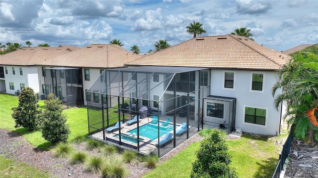 1452 Mickelson Ct, Davenport, FL 33896 - back of house featuring stucco siding, a tile roof, and a patio area