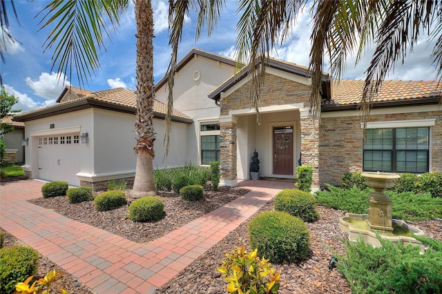 1452 Mickelson Ct, Davenport, FL 33896 - view of front of property with stucco siding, stone siding, a garage, and a tile roof