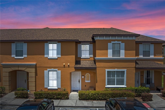2708 Camaro Dr, Kissimmee, FL 34746 - view of property with roof with shingles and stucco siding