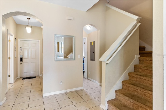 2708 Camaro Dr, Kissimmee, FL 34746 - foyer featuring arched walkways, light tile patterned floors, electric panel, and stairway